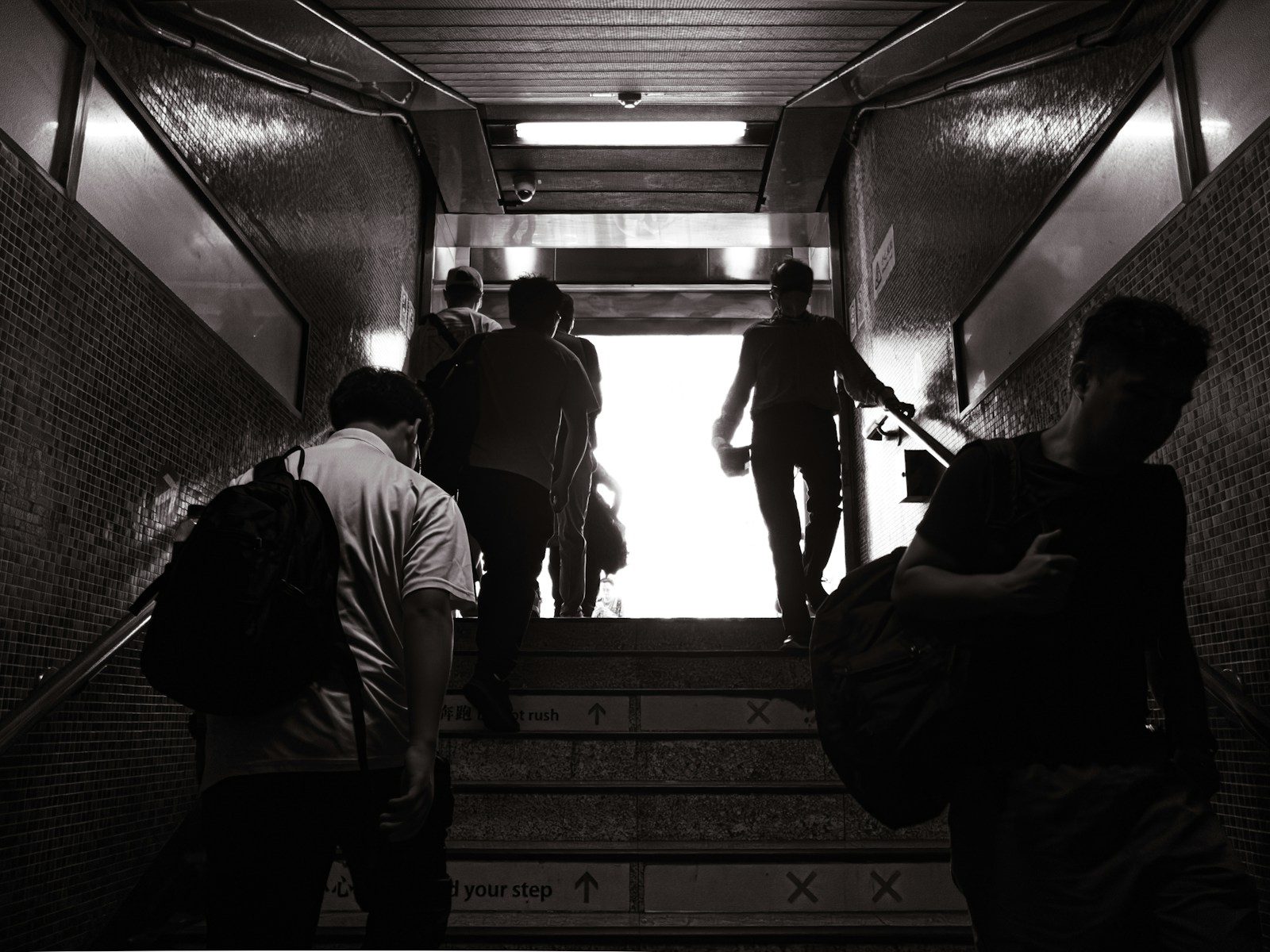 A group of people walking down a flight of stairs